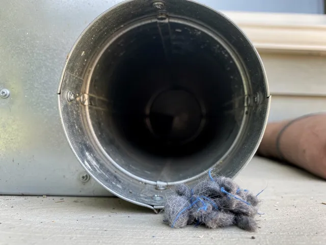 Maple Heights Dryer Vent Cleaning technician using specialized equipment to clear severe dryer vent blockage in Maple Heights